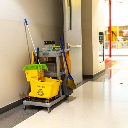 Cleaning tools cart wait for maid or cleaner in the department store. Bucket and set of cleaning equipment in the mall. Concept of service, worker and equipment for cleaner and health